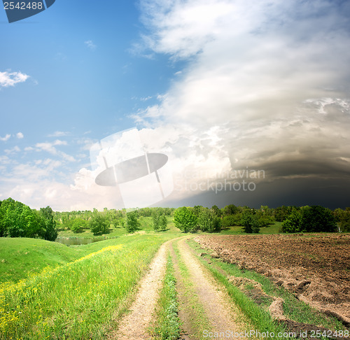 Image of Country road and storm clouds