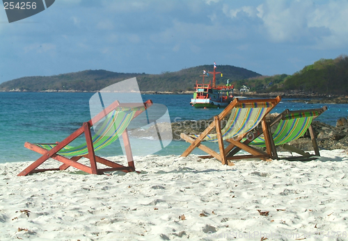 Image of Three chairs on the beach