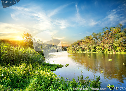 Image of Sunrise over the forest river