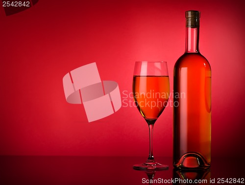 Image of White wine on a red background