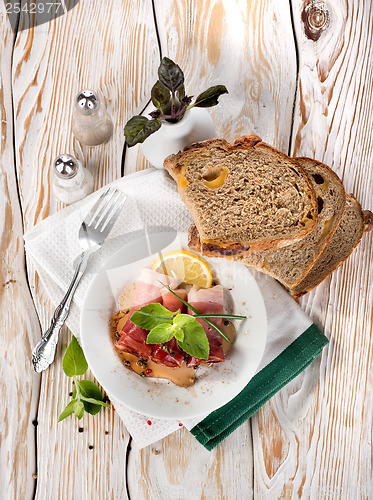 Image of Bacon and bread on a wooden table