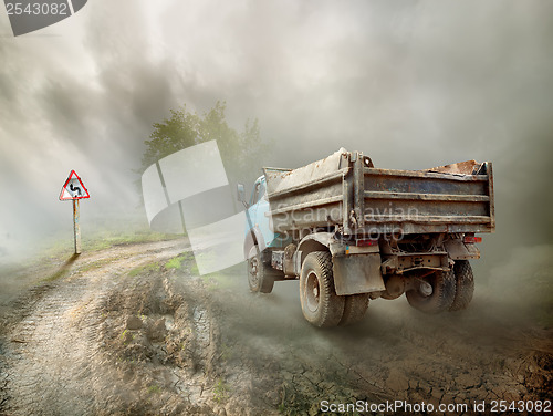 Image of Dirty truck on a country road