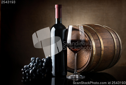 Image of Red wine and wooden barrel