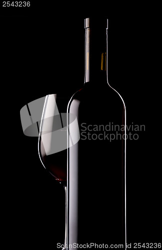 Image of Glass and bottle of red wine