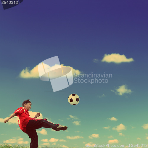 Image of asian boy playing football - vintage retro style