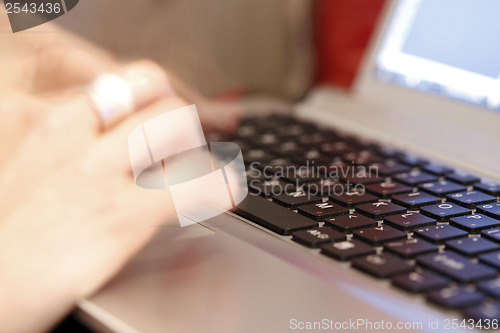 Image of Young woman working on laptop