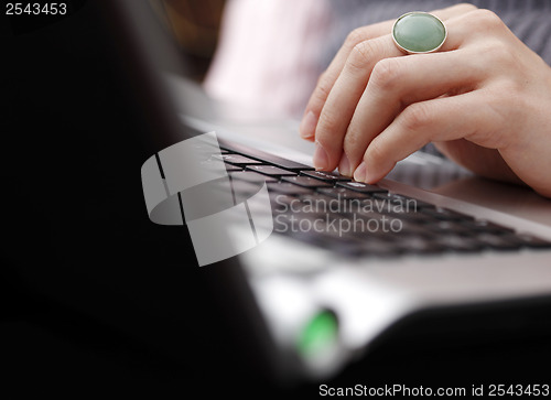Image of Young woman working on laptop