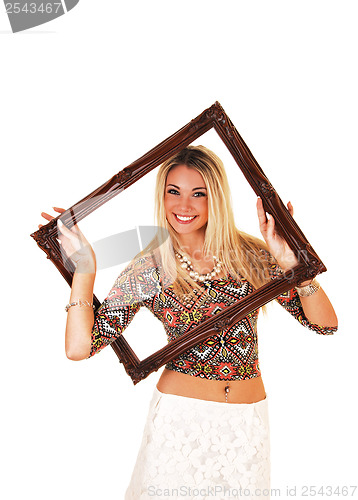 Image of Girl looking trough picture frame.