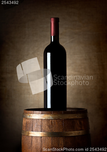 Image of Bottle of wine on a barrel