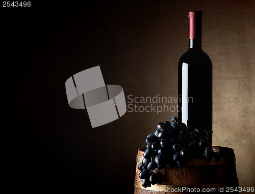 Image of Wine and grape on a barrel