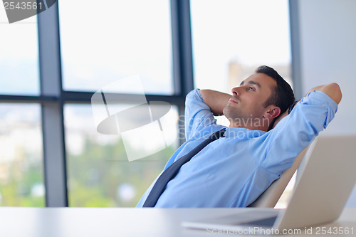 Image of happy young business man at office