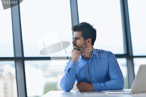 Image of happy young business man at office
