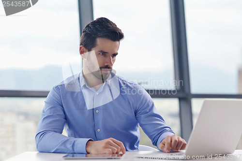 Image of happy young business man at office