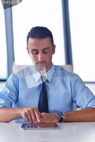 Image of business man using tablet compuer at office