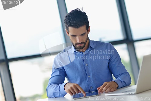 Image of business man using tablet compuer at office