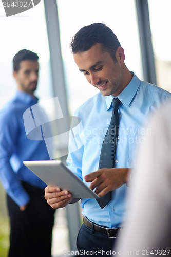 Image of business man using tablet compuer at office