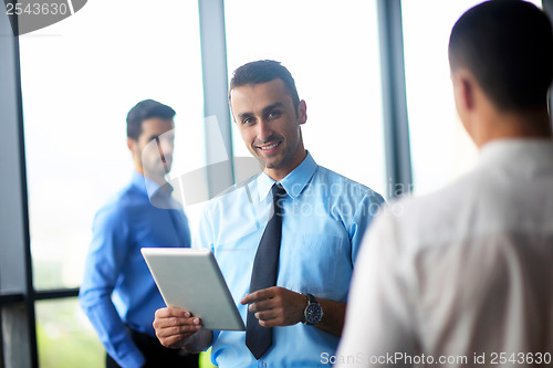 Image of business man using tablet compuer at office