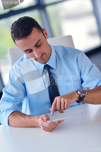 Image of business man using tablet compuer at office