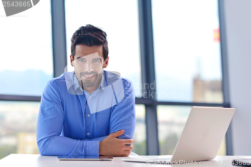 Image of happy young business man at office