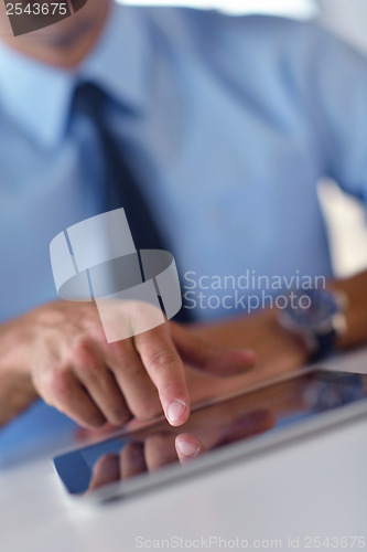 Image of business man using tablet compuer at office