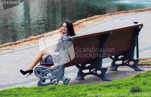 Image of Woman sitting near the lake