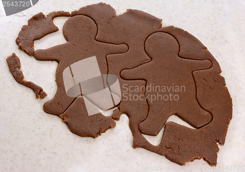 Image of Two gingerbread men in cookie dough