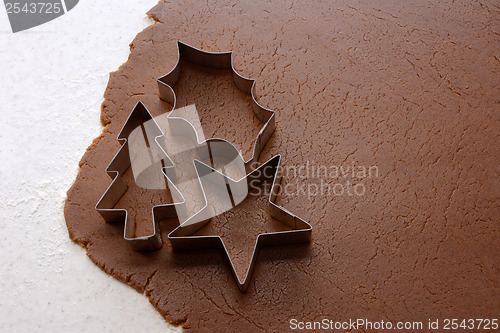 Image of Cutting out Christmas shapes from gingerbread dough