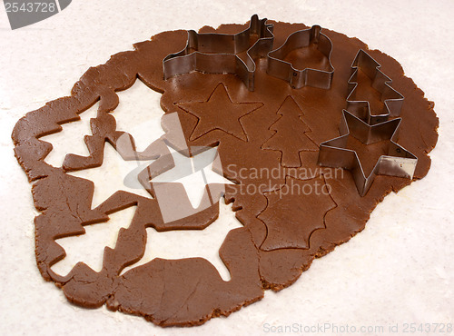 Image of Gingerbread dough cutout shapes and biscuit cutters