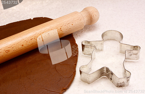 Image of Gingerbread dough, rolling pin and cookie cutter