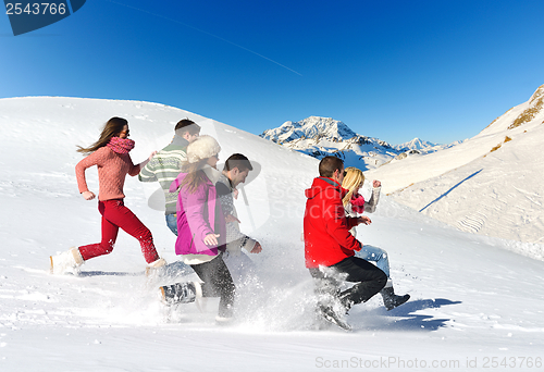 Image of friends have fun at winter on fresh snow