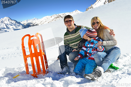 Image of family having fun on fresh snow at winter vacation