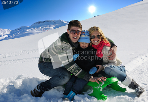 Image of family having fun on fresh snow at winter vacation