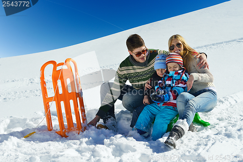 Image of family having fun on fresh snow at winter vacation