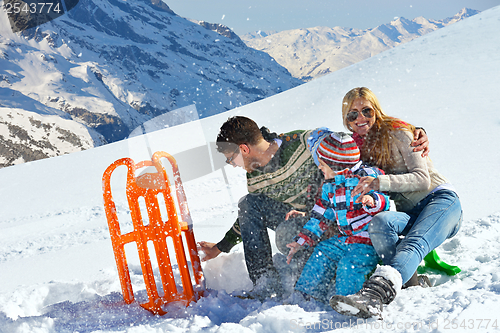 Image of family having fun on fresh snow at winter vacation