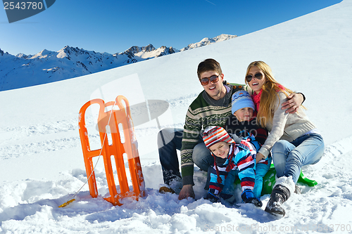 Image of family having fun on fresh snow at winter vacation