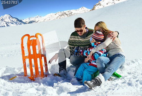 Image of family having fun on fresh snow at winter vacation