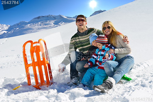 Image of family having fun on fresh snow at winter vacation