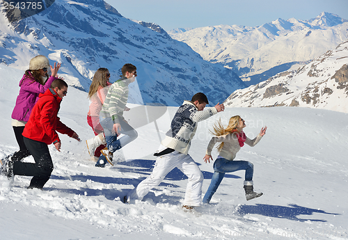 Image of friends have fun at winter on fresh snow