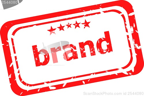 Image of brand on red rubber stamp over a white background