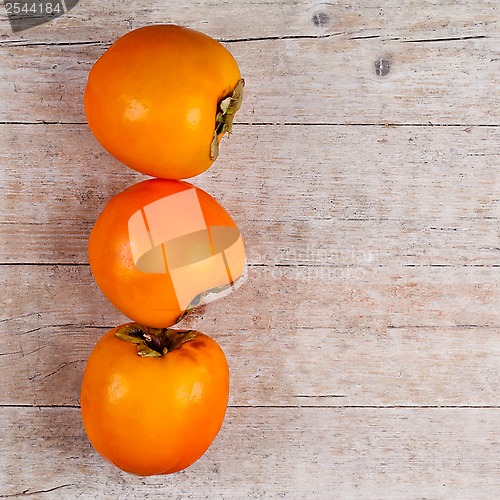 Image of three fresh persimmons 