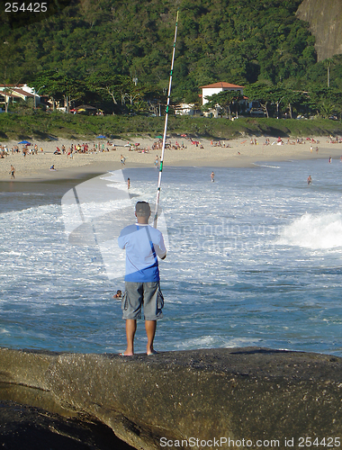 Image of Fishing on top of the rock at the beach