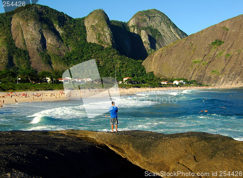 Image of Fishing on top of the rock at the beach