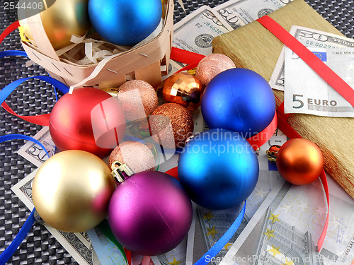 Image of Christmas gift box with christmas balls and money