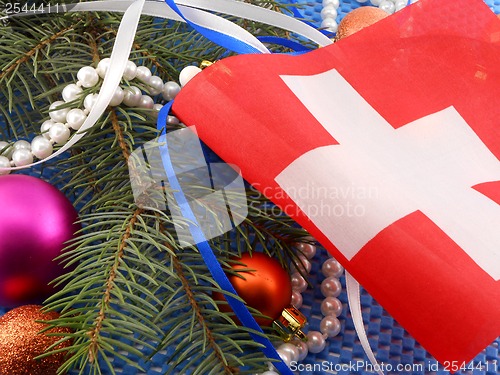 Image of switzerland flag with christmas decoration, new year card