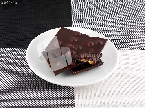 Image of Cracked chocolate parts in white plate