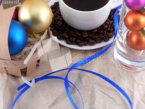 Image of cup of coffee with cinnamon, coffee beans and christmas balls