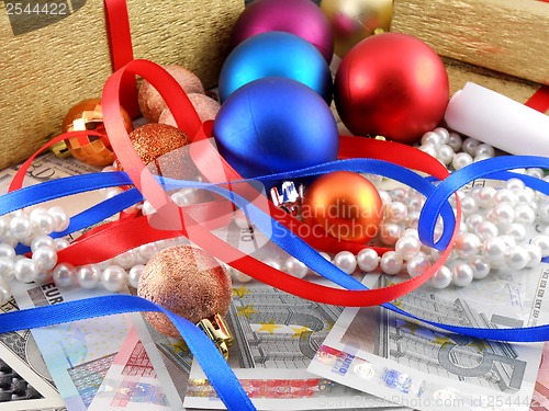Image of Christmas gift box, christmas balls, money and diamonds