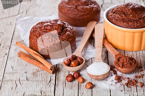 Image of fresh baked browny cakes, sugar, hazelnuts and cocoa powder 