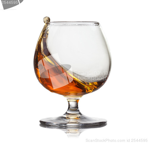 Image of Splash of cognac in glass isolated on white background