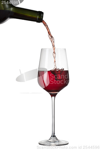 Image of Red wine pouring into glass with splash isolated on white